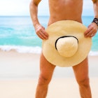 Close-up photo of man covering himself with summer hat